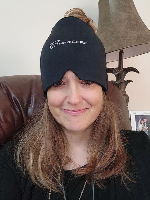 Reviewer wearing the cold therapy cap across their forehead