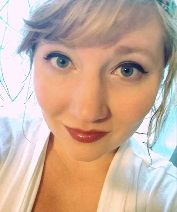 A reviewer applying the lip liner under a bold pink lipstick.