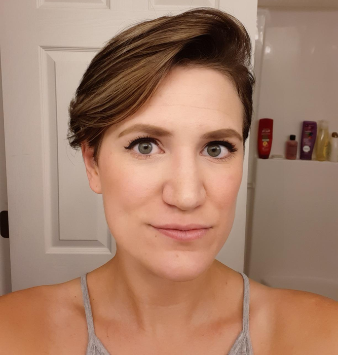 The same reviewer completing their eyeliner look by connecting the stamped wings to the inner corner of their eye with the eyeliner.
