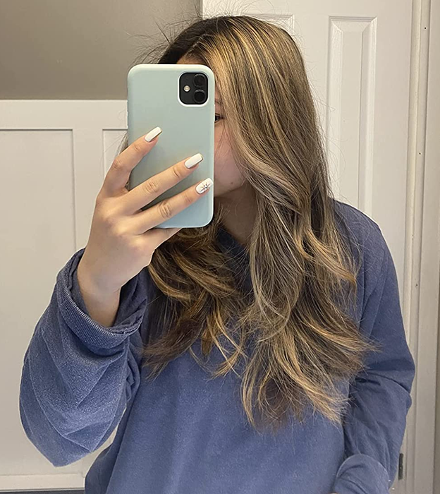 Reviewer with soft, loose waves in their hair.