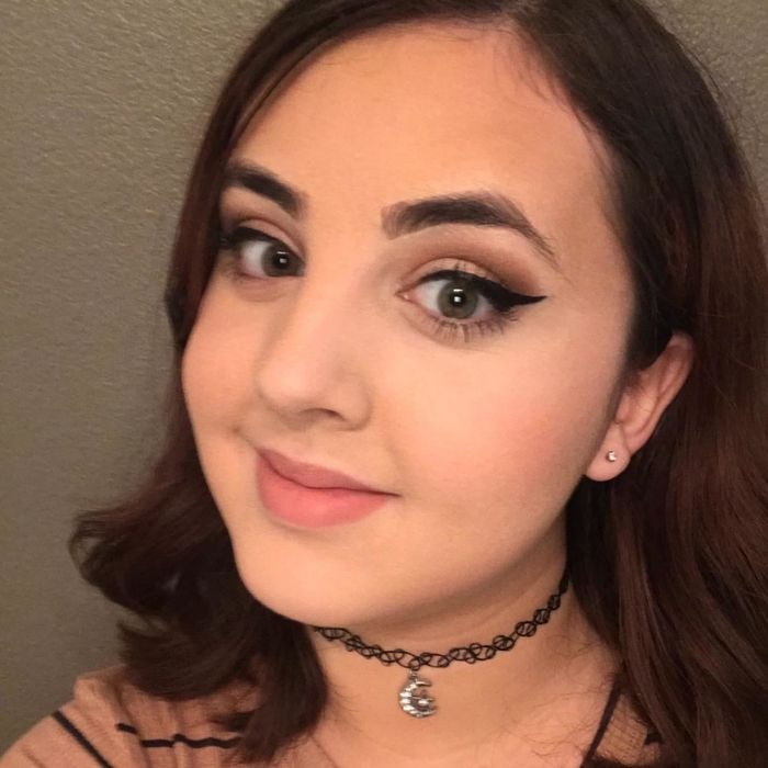 A reviewer sporting bold, dramatic winged eyeliner