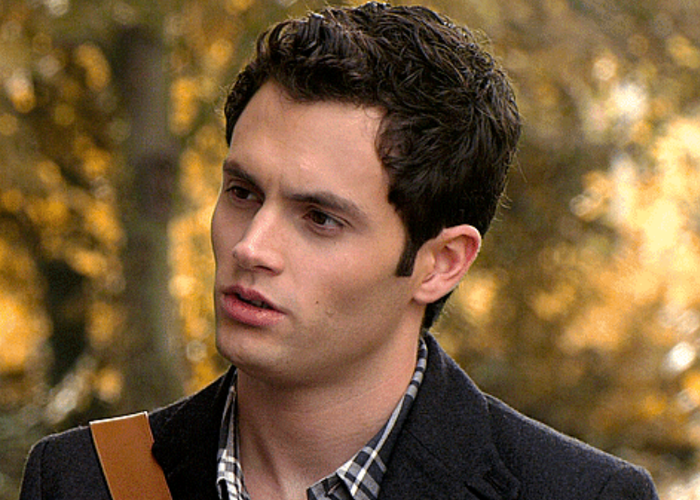 Dan standing outdoors in a relaxed environment, sporting a checkered shirt under a dark jacket, gazing to the side