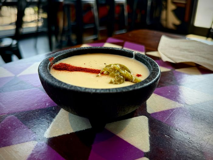 a bowl of soup placed on a table in a restaurant