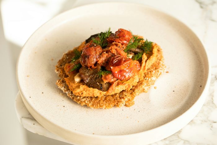 a white plate with food placed on a table surface