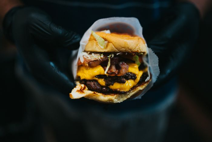 burger topped with cheese and lettuce