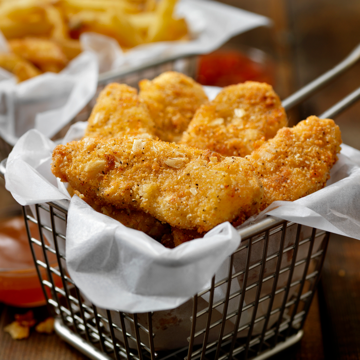 Vegan, plant-based protein chicken strips with a seven-grain coating, served with fries