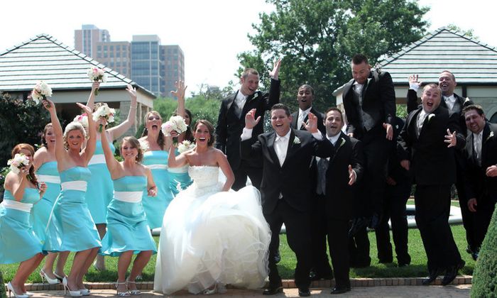 The bridal party gathered with the bride and groom, forming one large group