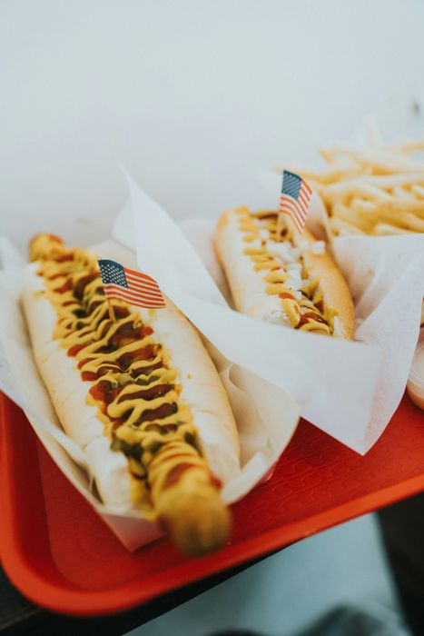 a closeup of two hotdogs on a tray