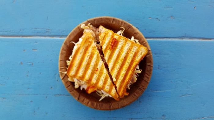 two sandwich slices on a brown dish