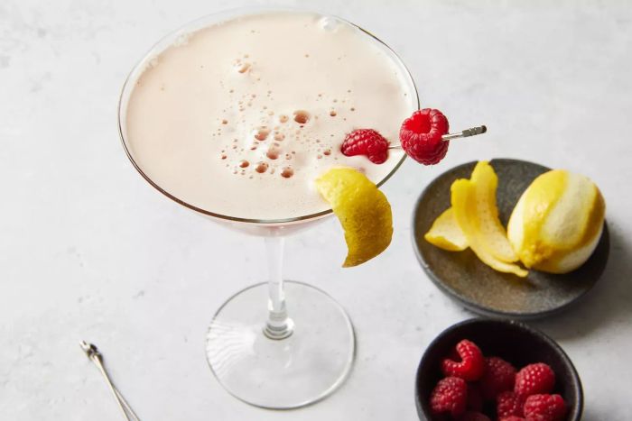 A Chambord French martini elegantly garnished with fresh raspberries and a twist of lemon peel