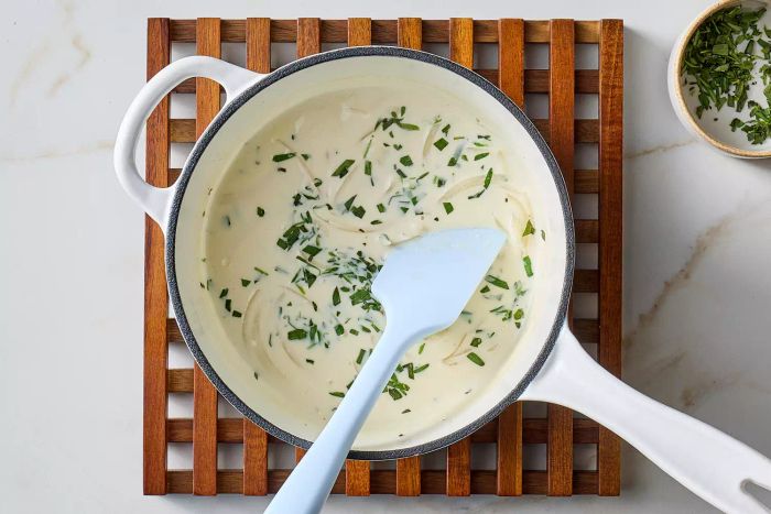 Tarragon cream sauce gently simmering on the stovetop.