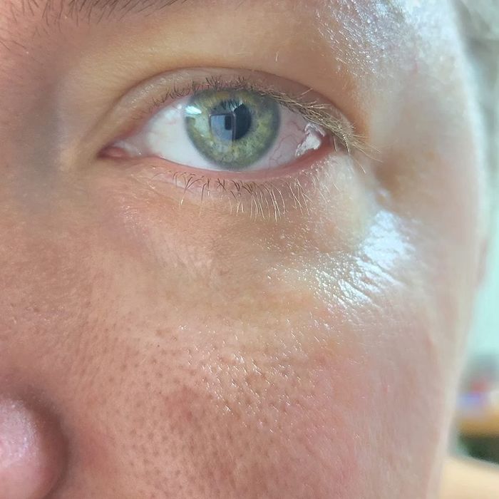 A reviewer's eye after using the Cerave eye cream, showing reduced puffiness