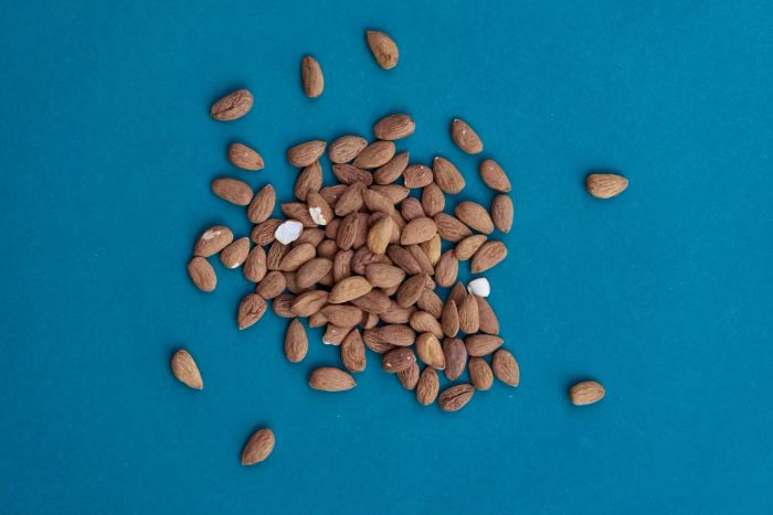 A bunch of almonds on a blue background
