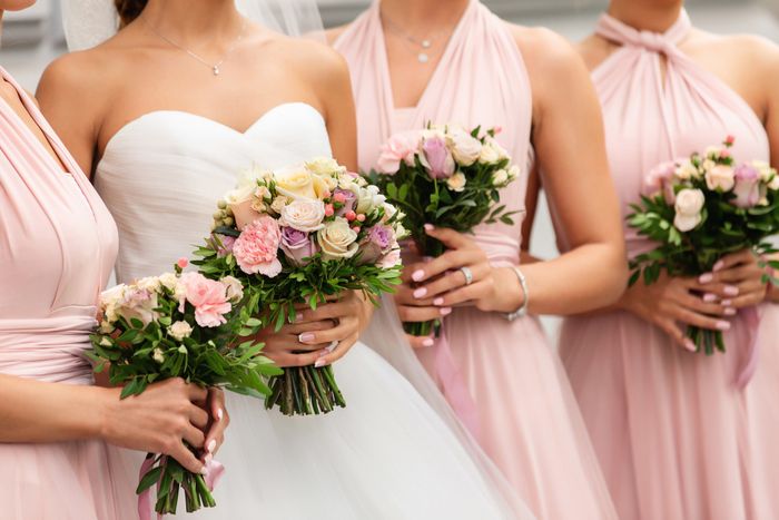 Bridesmaids standing next to the bride