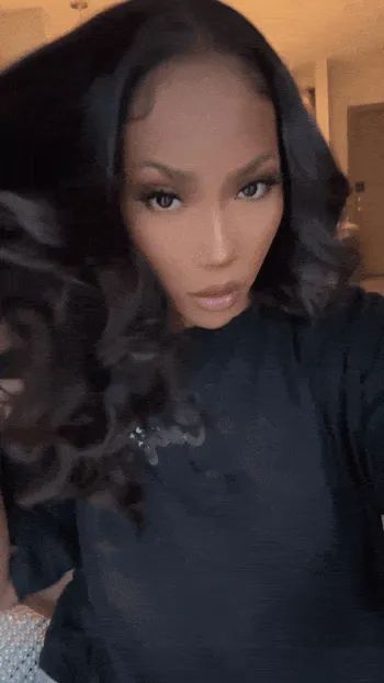 Jordan Grigsby wearing tape-in extensions and playing with their hair