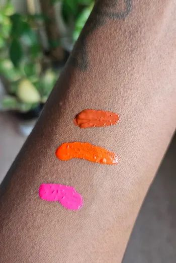 Three different shades of blush swatched on the reviewer's arm