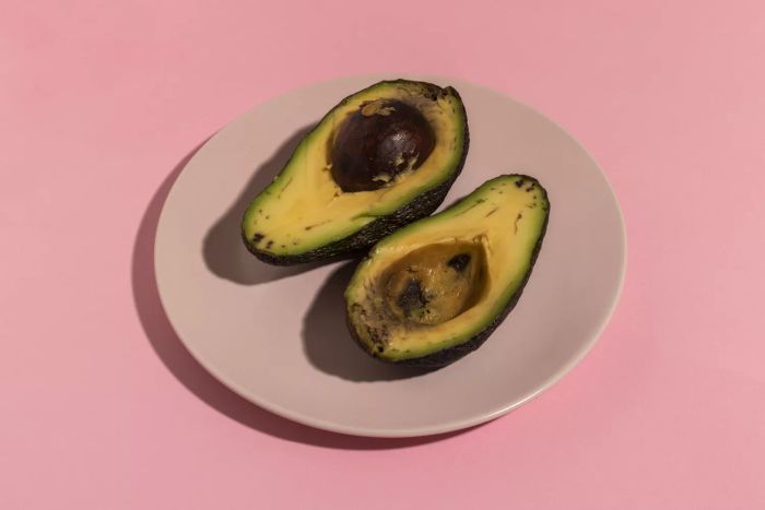 Brown avocado halves on a plate
