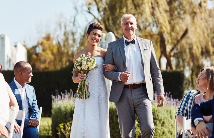 The bride walking down the aisle with her father