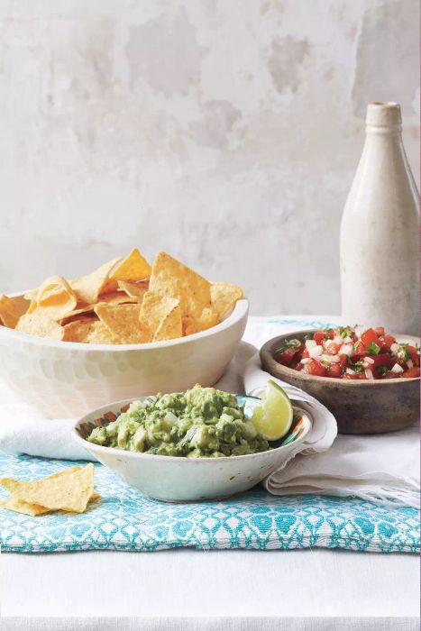 Guacamole and Pico de Gallo in Rustic Bowls Served Alongside a Large Bowl of Tortilla Chips