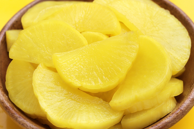 Tangy and sweet slices of yellow pickled daikon, called takuan in Japan and danmuji in Korea.