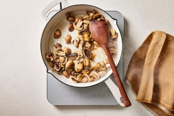 Mushrooms cooking in a skillet