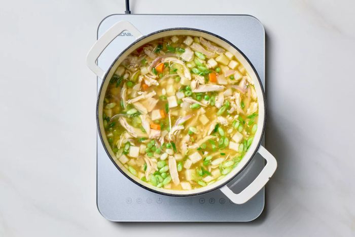 Ginger chicken soup simmering on the stovetop