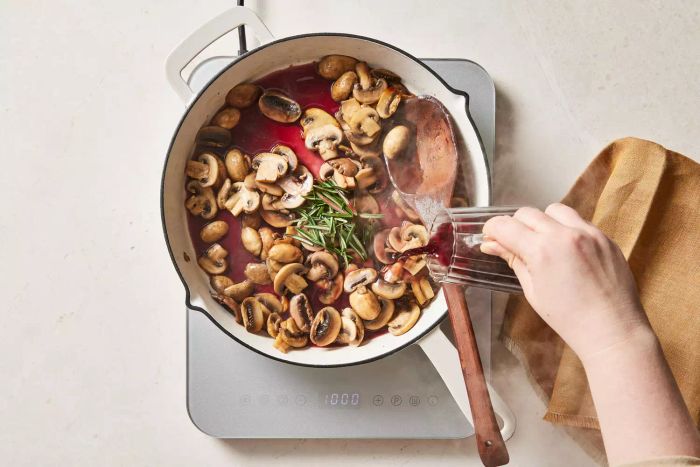 Stirring the red wine mushroom sauce on the stove