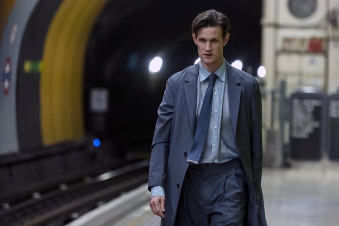 Matt, dressed in a suit, walks confidently through a subway station.