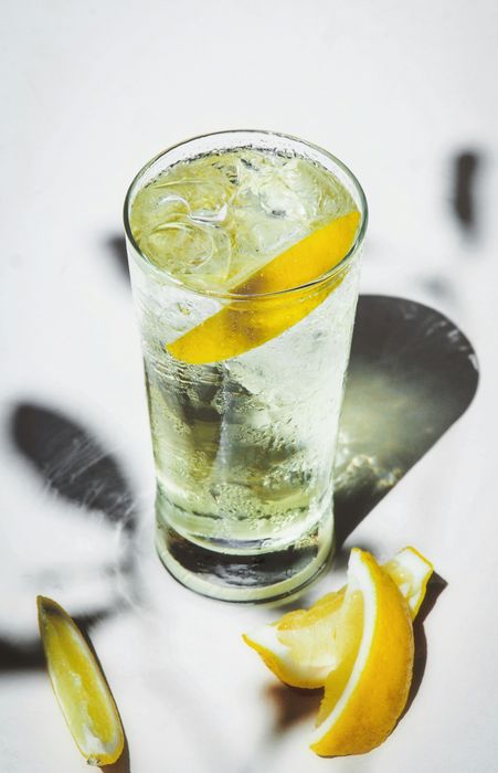 Clear glass filled with ice and a slice of lemon