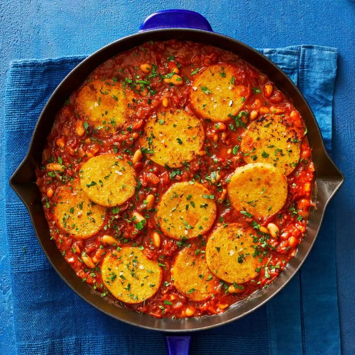 Skillet Polenta in Creamy Tomato Sauce With Beans, Served in a Cast-Iron Skillet on Top of a Blue Kitchen Towel