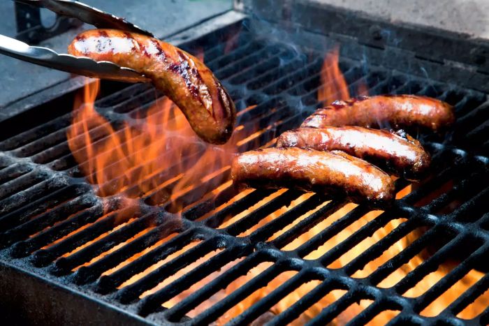 Grilled sausage cooking on a barbecue