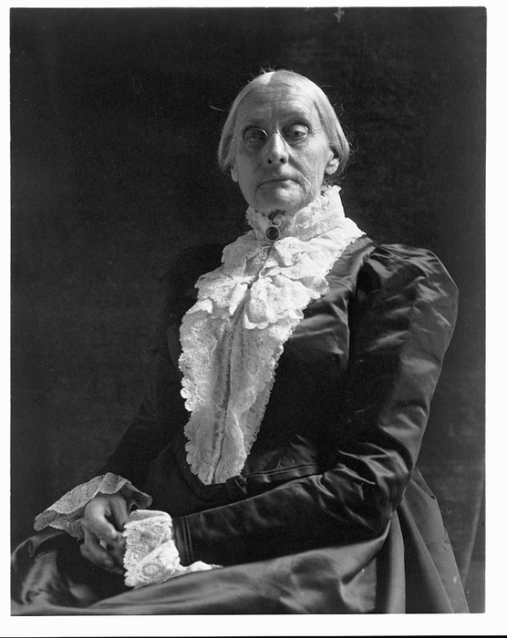 An archival photo showing an elderly woman seated in 19th-century formal wear with intricate lace details.