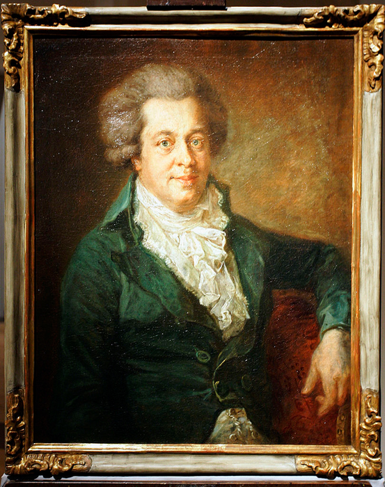 A timeless portrait of a man seated in historical attire, donning a ruffled shirt and jacket, framed in an intricate wooden border.