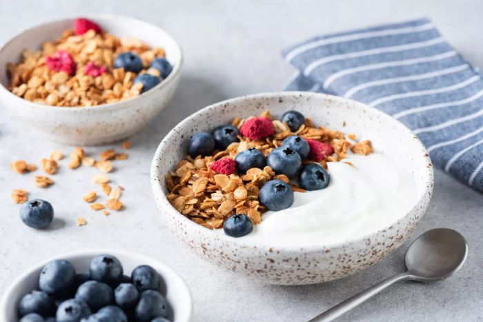 A bowl of yogurt topped with granola and fruit