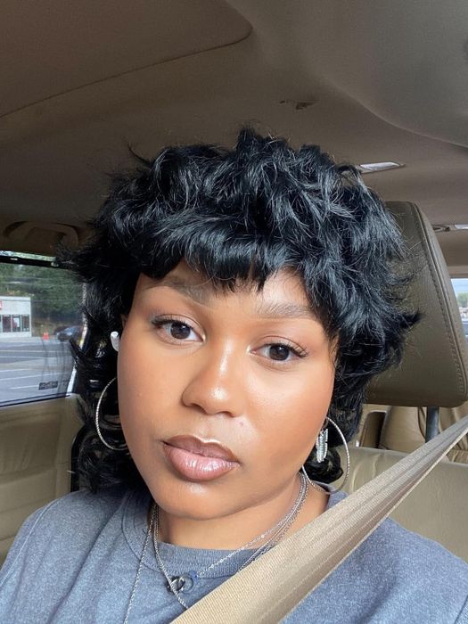 A reviewer showcasing their glowy makeup look