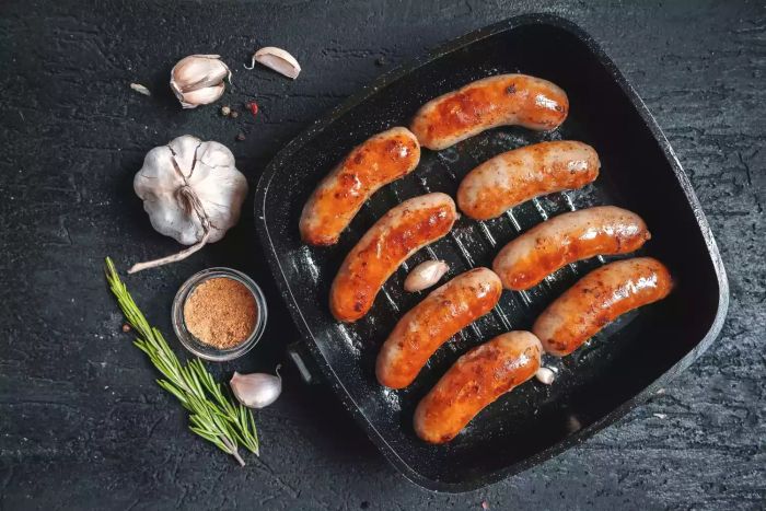 Sausage sizzling in a frying pan