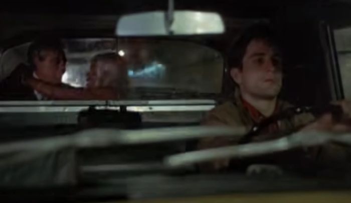 Robert is seen driving at night with a couple in the backseat, engaged in a conversation. The driver remains focused on the road ahead.