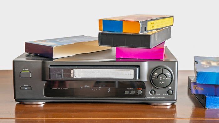 Stacks of VHS tapes resting on a VCR, sparking a wave of nostalgia
