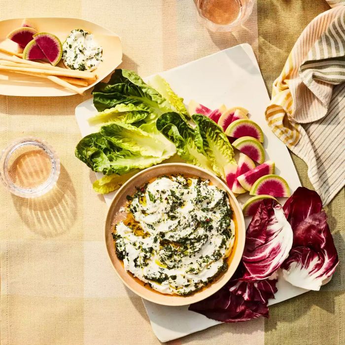 Overhead view of Chimichurri Yogurt Dip in a bowl surrounded by lettuce and cabbage