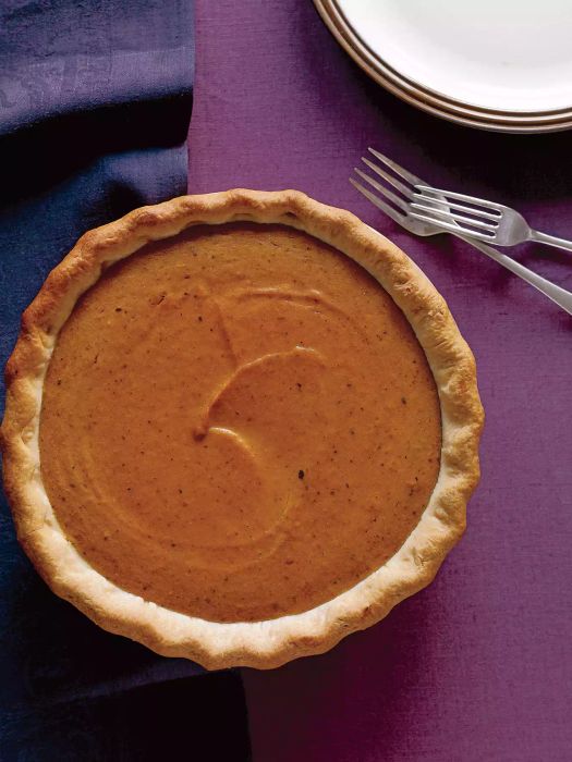 Top View of Maple Pumpkin Pie on Top of Purple Fabric with Two Metal Forks Next to It