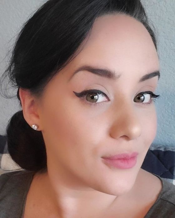 A reviewer showcasing the results of applying the wing-shaped eyeliner stamp