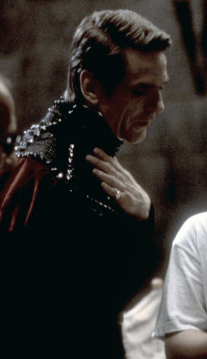 Jeremy, donned in a fantasy outfit with an extravagant collar, exudes a commanding presence.
