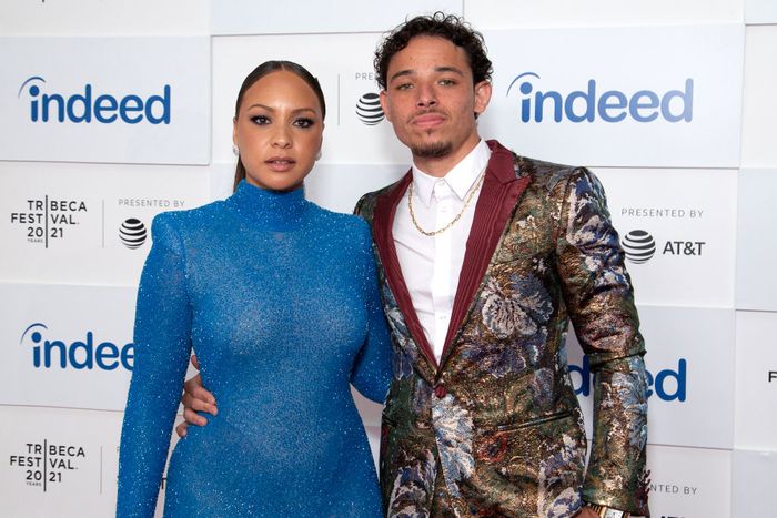 At a Tribeca Festival event, Jasmine dazzles in a sparkling gown, while Anthony stands out in a floral-patterned suit, embodying red carpet glamour.