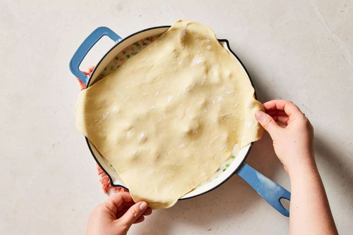 Placing puff pastry over the chicken pot pie filling