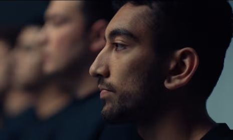 A profile of a person deep in thought, with blurred figures in the background.