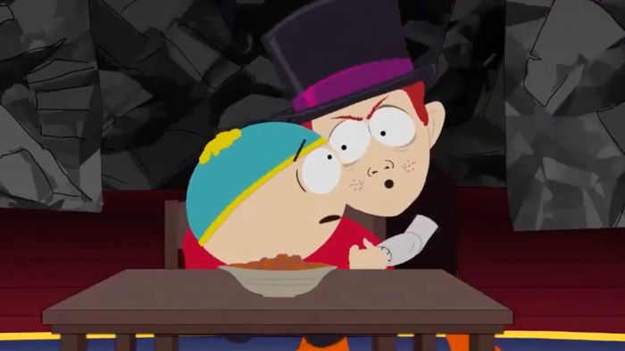 An animated scene featuring two cartoon characters, one wearing a top hat, seated at a table with a bowl. The setting is dimly lit.