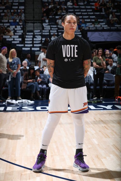 Brittney is seen on the court of a sports arena, wearing a