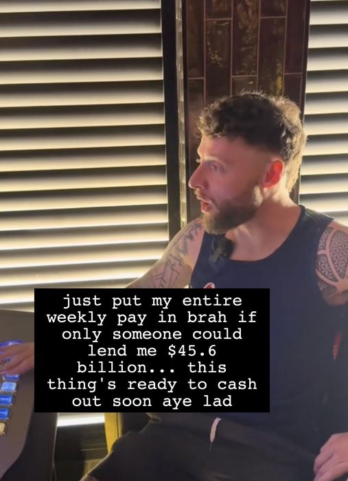 A man with tattoos, seated at a desk, wearing a sleeveless shirt, and speaking enthusiastically. Text on the image: 'to pop aye.'