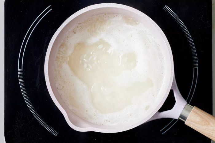 A pot of jasmine rice boiling on the stovetop