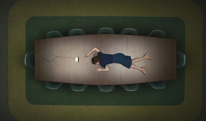 A person in office attire lies face down on a large conference table in a boardroom, with a computer mouse lying beside them.
